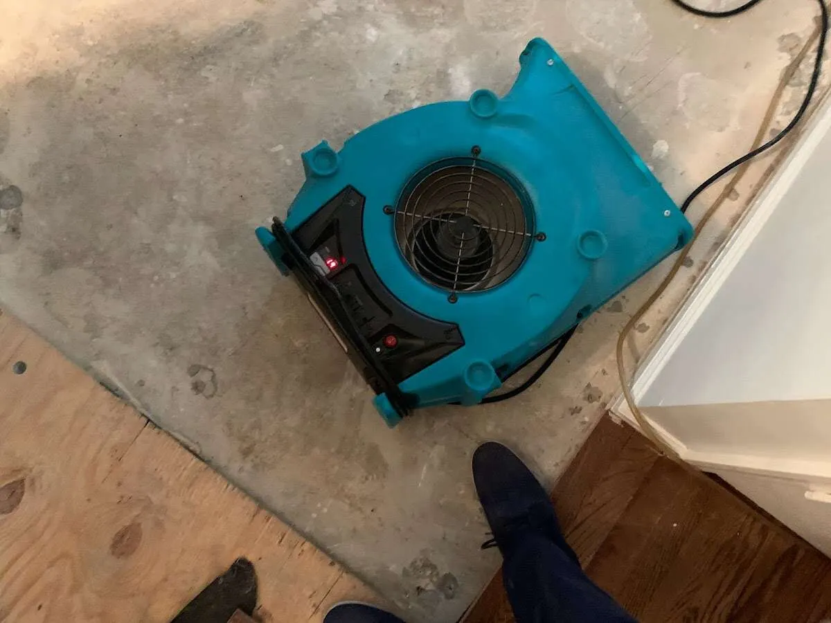 Air mover drying subfloor during Commercial Water Damage Restoration in Telford